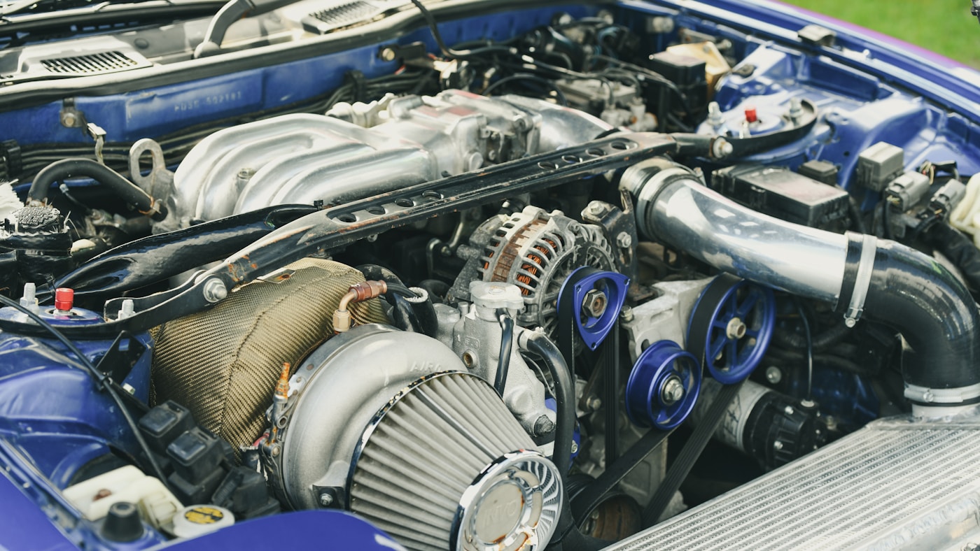 Mechanic working on diesel engine cylinder head at repair shop